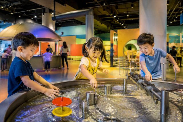 Children learning through interactive water play at a children’s museum in Singapore