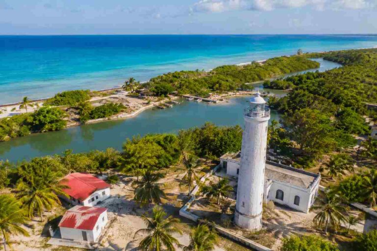 Sisal, Yucatán: A Complete Guide to Its History, Beaches, Nature, and Henequén Legacy Aerial view of Sisal, Yucatán coastline with turquoise water, lush vegetation, and historic lighthouse
